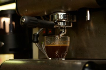 Cup of coffee in coffee machine 