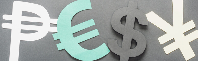 top view of peso, euro, dollar and yen sign on grey background, panoramic shot
