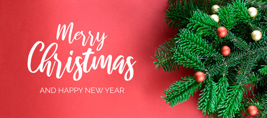 Merry Christmas and Happy New Year Sign with spruce branch banner. Christmas red background with ornate spruce branch stock images. Elegant holiday background. Red Christmas greeting card