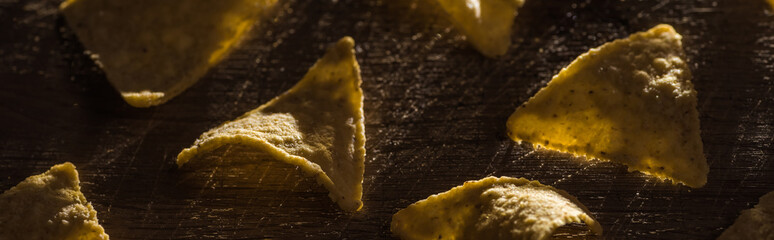 delicious crispy corn nachos on wooden rustic table, panoramic shot