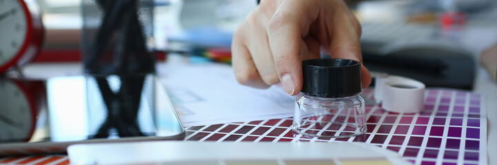 Male serviceman hold in hand magnifying glass making colour test