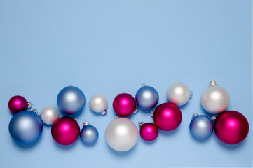 Christmas balls on a blue background. Pastel colors. Christmas concept. Composition of the Christmas decorations isolated on light blue.