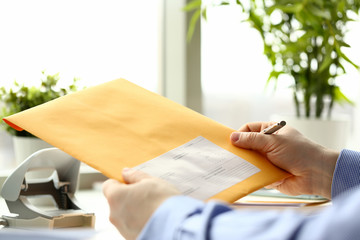 Businessman hold hand yellow mail envelope