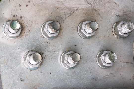 rough metal bolt and nut fastening close-up  on the structure