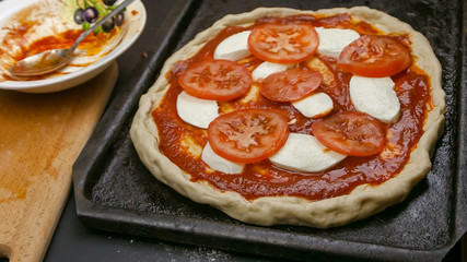 cooking pizza Margarita . after Assembly before baking