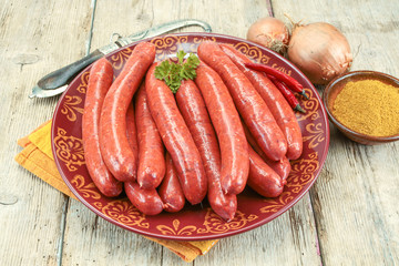 several raw merguez on a plate