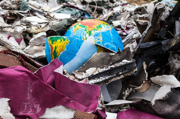 Broken terrestrial globe in the garbage