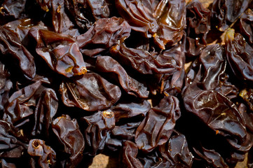 Dried healthy grapes photographed on a wooden surface close-up.