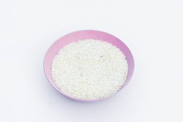 Raw dry rice in separate bowls on a white background