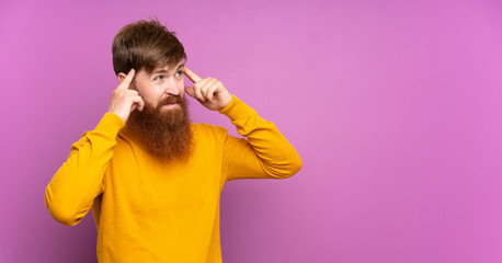 Redhead man with long beard over isolated purple background having doubts and thinking