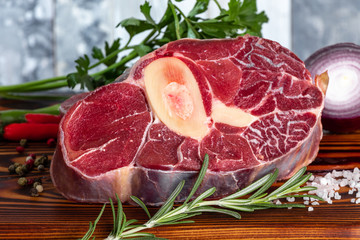 Meat beef veal shank sliced meat on dark  wooden cutting board.