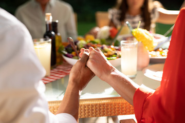 Family eating outside together in summer
