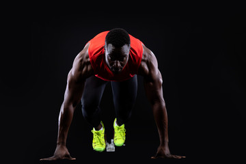 Male runner on starting blocks