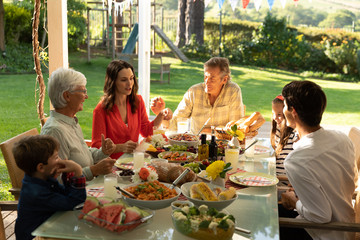 Family eating outside together in summer