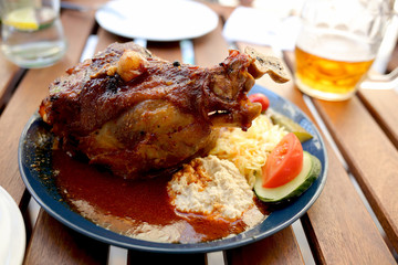 Traditional Czech dinner with fried pork leg and beer in a restaurant.   Travel and vacation. Close up