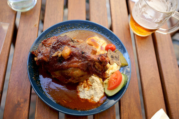 Traditional Czech dinner with fried pork leg and beer in a restaurant.   Travel and vacation. Close up