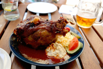 Traditional Czech dinner with fried pork leg and beer in a restaurant.   Travel and vacation. Close up