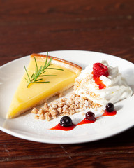 Fresh tasty lemon tart with crumble and whipped cream