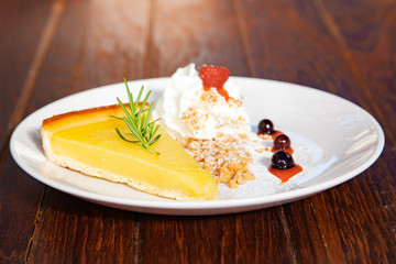 Fresh tasty lemon tart with crumble and whipped cream
