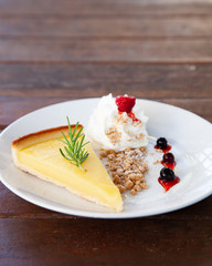 Fresh tasty lemon tart with crumble and whipped cream