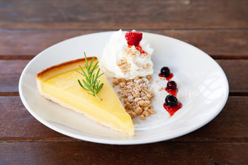 Fresh tasty lemon tart with crumble and whipped cream