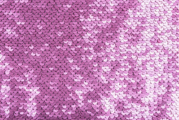 Pink purple shiny fabric with sequins, abstract background.
