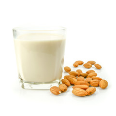 almond kernel and almond milk in the glass isolated on white background