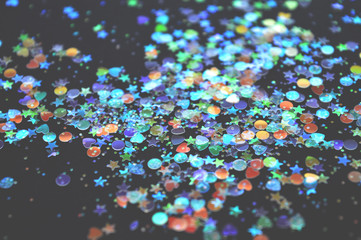 Blurry colorful glitter in vintage colors on black background, shiny confetti, kamifubiki nail art