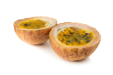 Whole passionfruit and a half maracuya fruit (Passiflora edulis) isolated on white background
