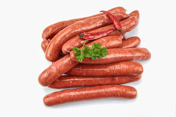 several raw merguez on a white background