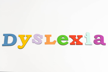 top view of dyslexia lettering isolated on white - obrazy, fototapety, plakaty