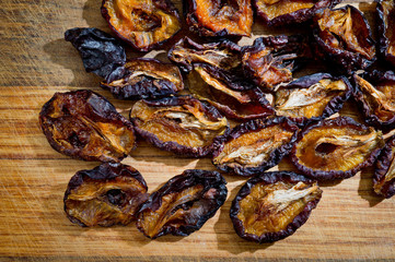 Close-up dried plums, sliced for health, photographed on a wooden surface close-up.