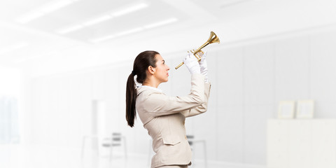 Woman playing trumpet brass instrument
