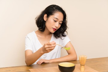 Obraz na płótnie Canvas Young asian girl with tea matcha