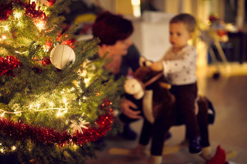 Christmas tree in focus and blured family