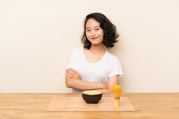 Obraz na płótnie Canvas Young asian girl with tea matcha smiling a lot