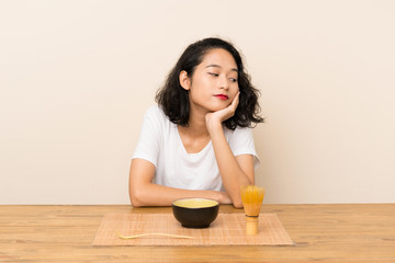 Obraz na płótnie Canvas Young asian girl with tea matcha