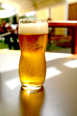 beer mug on a wooden table stands in a pub