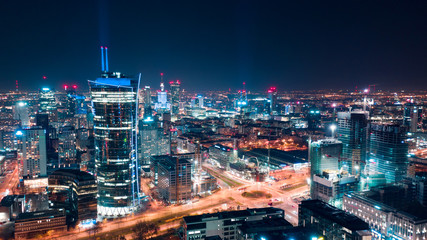 Fototapeta Aerial view of Warsaw business center at night: skyscrapers and Palace of Science and Culture obraz