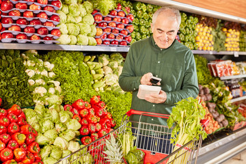 Senior Mann beim Scannen von einem Lebensmittel