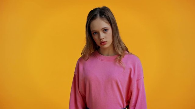 cropped view of woman using clapboard, teenager posing isolated on yellow