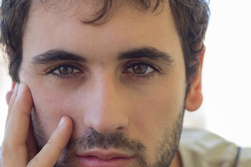 Obraz premium Close-up of caucasian boy with beard and clear eyes. Smiling expression Focus on the eyes