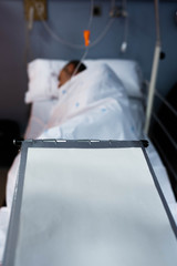 coronavirus Covid 19 senior man plus year old man recovering from surgery in a hospital bed.
