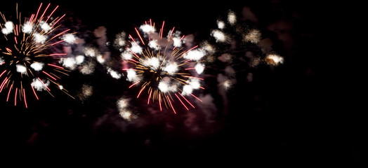 Flashes of fireworks in the night sky. Abstract photo of bright lights