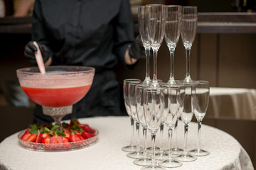 A pyramid of glasses. pink champagne with fruits.