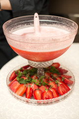 A pyramid of glasses. pink champagne with fruits.
