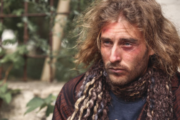 Portrait of poor homeless man outdoors