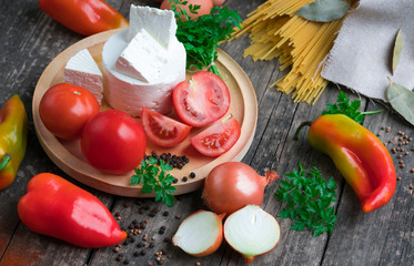 .Italian food ingredients - pasta, vegetables, eggs on a wooden background