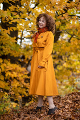 Seasonal portrait of a mature woman outdoor in vibrant forest