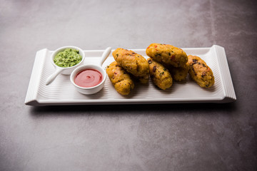 Veg Poha Roll made using flattened Rice, served with tomato ketchup and green chutney